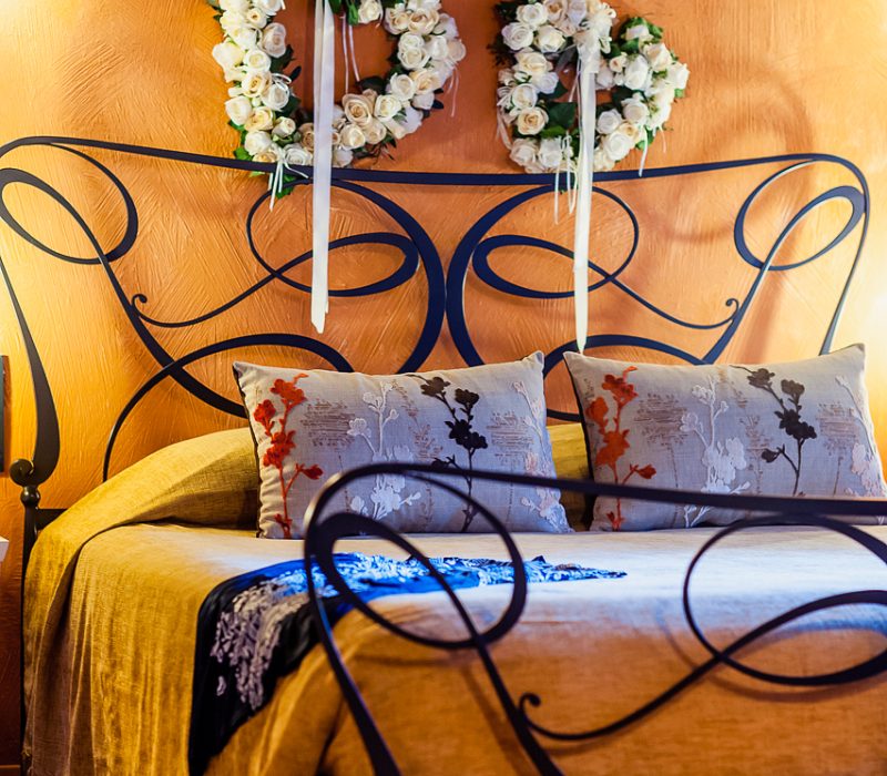 Eros Junior Suite bedroom with wrought-iron king-size bed